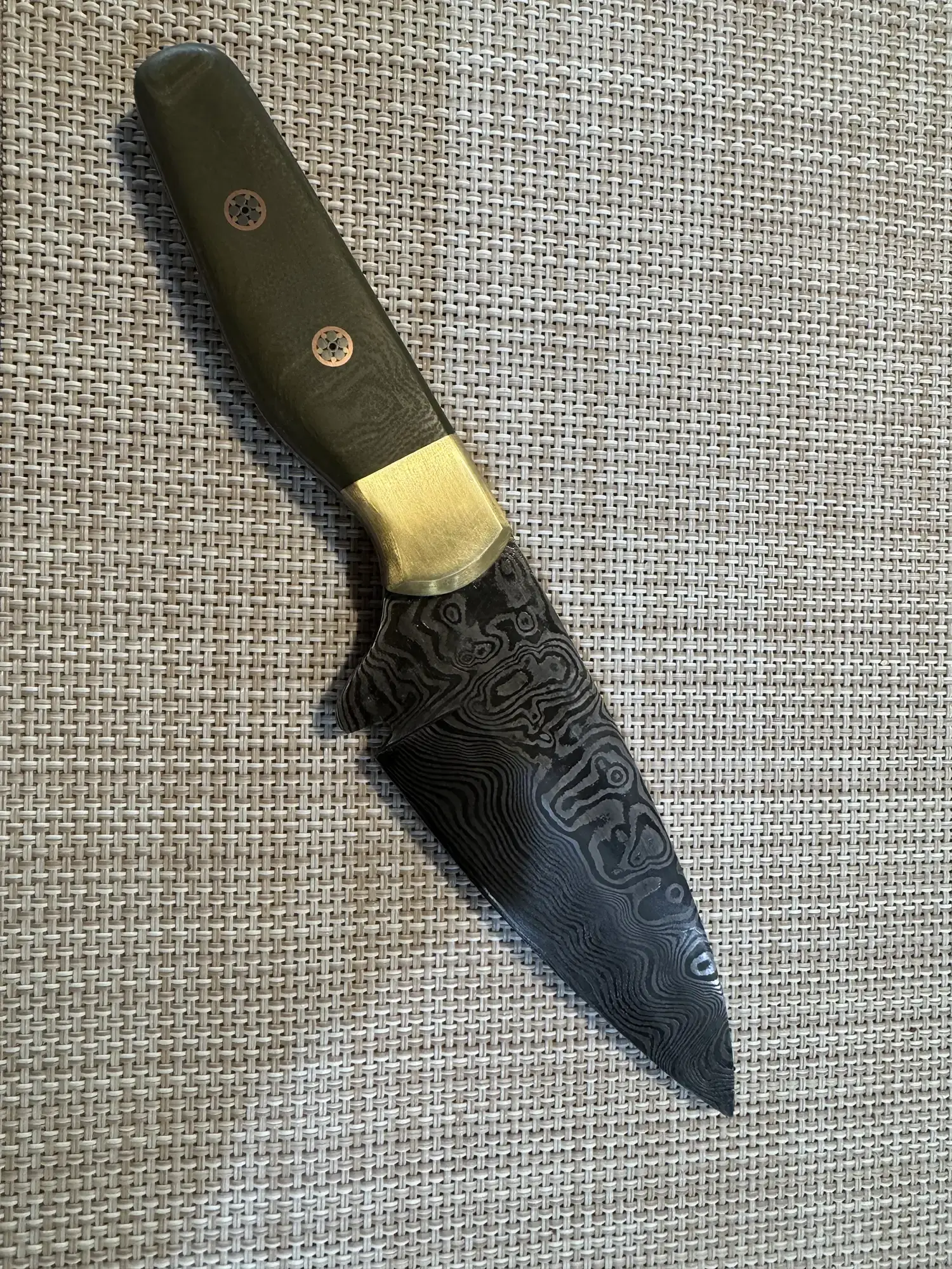Handcrafted Damascus steel knife with dark wood handle and gold bolster